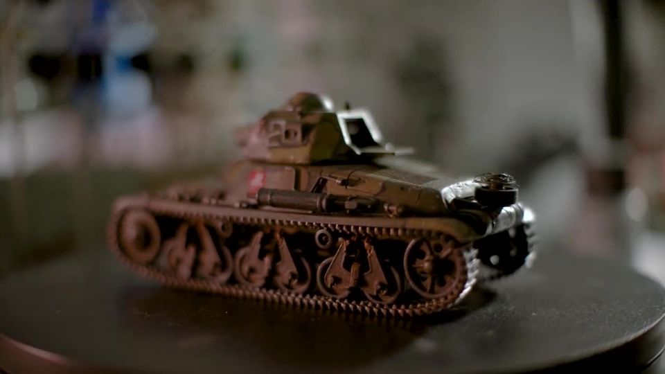 Weathered miniature tank model resting on a round display turntable